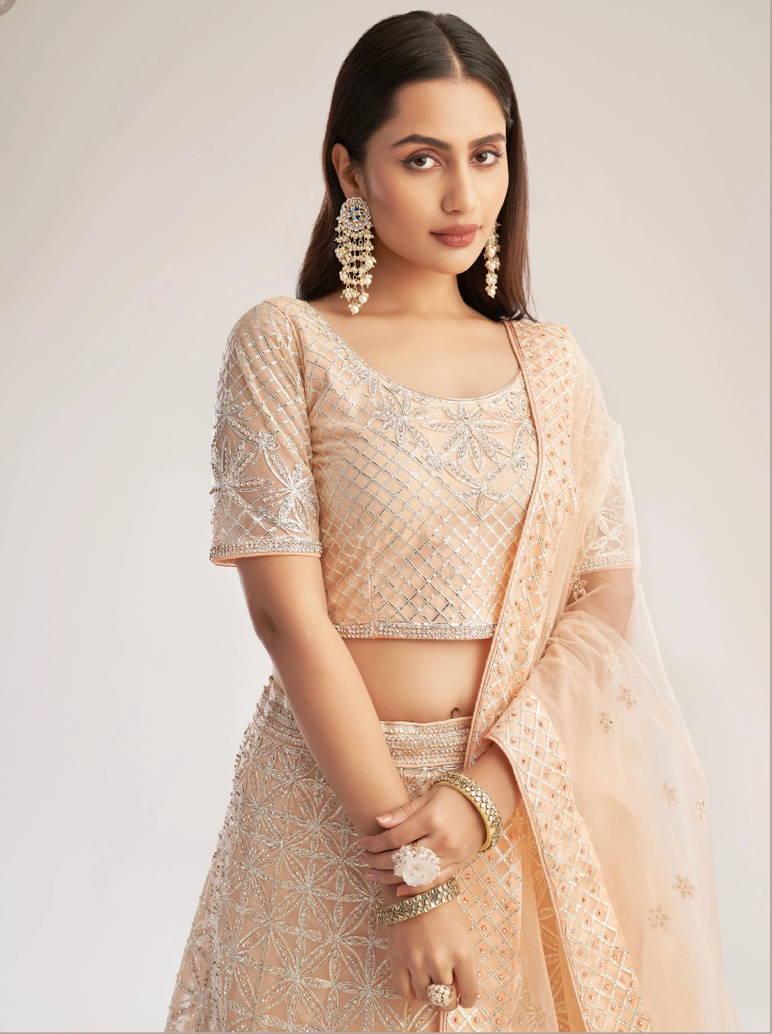 Elegant Peach Net Bridal Lehenga with Ribbon Gota Work and Heavy Zarkan Embellishments