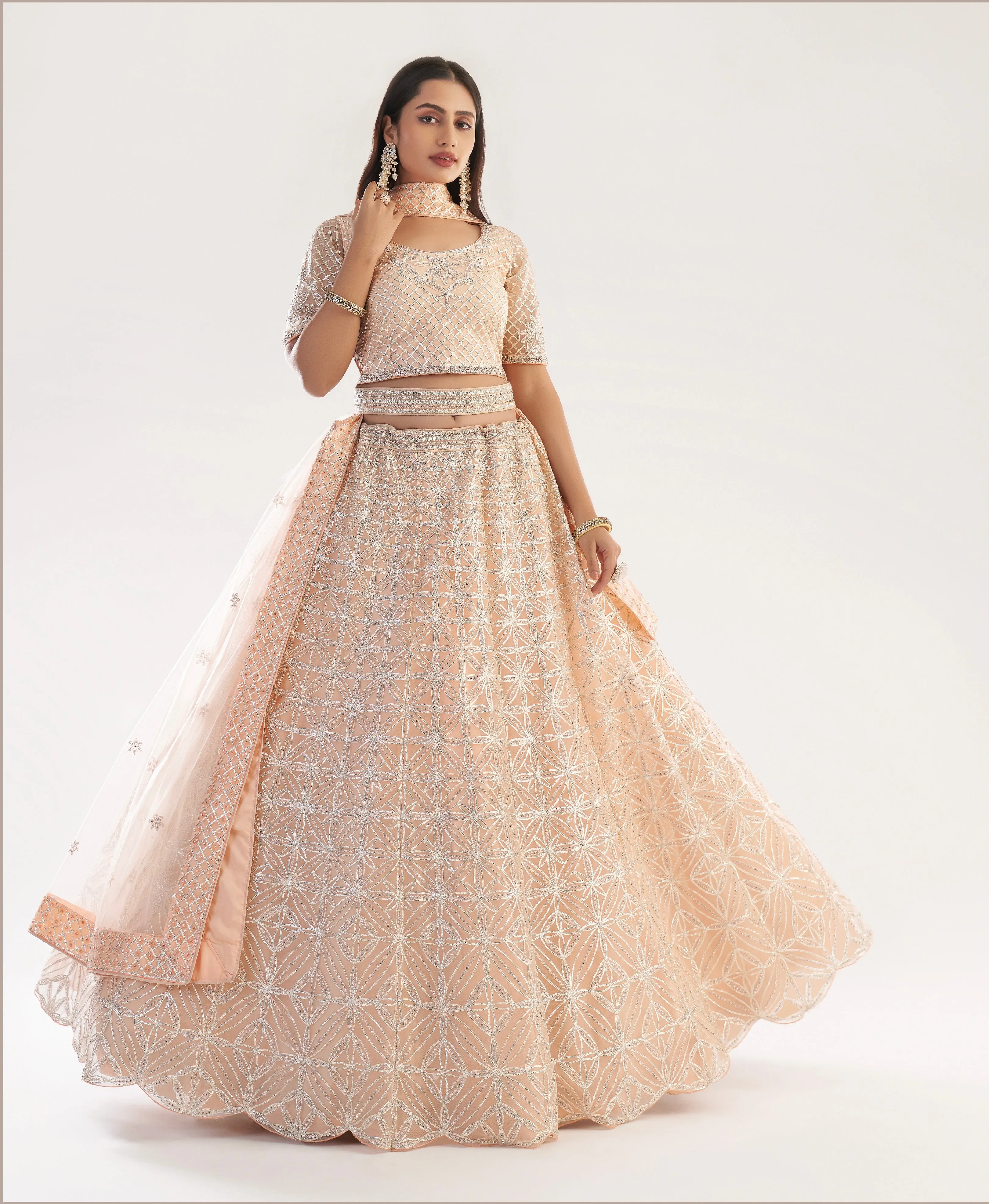 Elegant Peach Net Bridal Lehenga with Ribbon Gota Work and Heavy Zarkan Embellishments